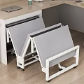 Foldable Single Bed With Gray Mattress And White Frame By Desk On Wooden Floor