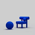Modern Blue Upholstered Lounge Chair With Round Ball Accent And Curved Design Elements
