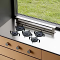 Modern Five Burner Gas Stove On Stainless Steel Countertop By Window With Green Grass