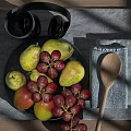 Fresh Pears and Red Grapes on Gray Placemat with Plate Wooden Spoon and Gray Cup