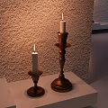 Decorative Ornament Set With Lit Candles On Wooden Candlesticks Of Different Heights And Textured Wall