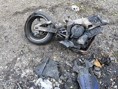 Burned Motorcycle Remains With Debris And Ash On Gravel Ground 3d model