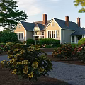 Charming Residential Garden Landscape With Winding Stone Path And Vibrant Blooming Flowers Around Cozy Home