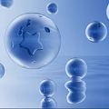 Colorful Transparent Bubbles Floating On Water Surface With Blue Sky And Cloud Reflections