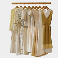 Light Colored Fashionable Clothes Hanging On Wooden Hangers With Striped And Dotted Patterns