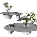 Modern Oval Coffee Table With Smooth Surface Cylindrical Legs And Small Plant Decor