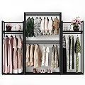 Colorful Clothes Hanging On Black Metal Rack With Floral Patterns And Pink Flowers Vase