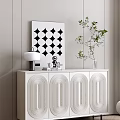 Modern White Entryway Side Cabinet with Carved Panels Lamp Sculpture Green Plant and Wall Art
