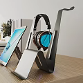 Modern Iron Stand For Headphones And Tablet On Wooden Table With Books