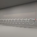 Hanging Art Installation With Silver Circular Rings And Red Ropes On Gray Background