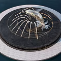Park Landscape Featuring Circular Fountain With Silver Fish Sculpture And Golden Curved Structures