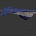Patterned Blue Fabric Draped Over Metal Frame Table With Gray Top Surface