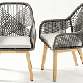 Woven Armchairs With Light Gray Cushions And Natural Wooden Legs Design