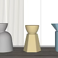 Modern Gray Beige Blue Stools With Different Designs On Vertical Striped Wall And Wooden Floor