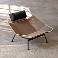 Modern Brown Woven Leisure Chair With Metal Frame Black Cushion And Sunlight Shadows