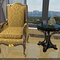 Elegant Accent Chair with Yellow Floral Upholstery Wooden Accents Beside Black Round Table City View