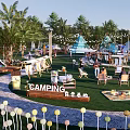 Vibrant Camping Site With Colorful Tents Palm Trees And Green Lawn
