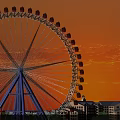 Ferris Wheel Amusement Ride With Sunset Sky And City Buildings View