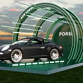Porsche Sports Car Photo Check in Spot with Green Circular Structure and Sunset Sky