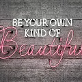 Stylish Neon Decorative Light with Be Your Own Kind of Beautiful Text on Wooden Wall