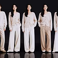 Five Women In Neutral Tone Knit Cardigans And Wide Leg Pants Standing In A Row