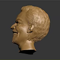 Detailed Golden Human Head Sculpture With Shiny Metallic Surface And Smiling Expression