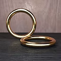 Polished Golden Bracelets Displayed On Dark Surface With Wooden Background