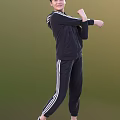 Woman In Black Tracksuit With White Stripes Performing Stretching Against Green Background