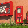 Red Fire Equipment Setup With Fire Box Hose Cabinet Extinguishers And Green Plants On Grass