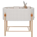 Light Colored Padded Baby Crib With Wooden Frame And Plush Rabbit Toys