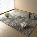 Black and White Geometric Pattern Square Rug on Wooden Floor with Vase Flowers and Magazines