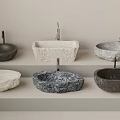 Elegant Stone Washbasins with Textured Surfaces and Various Shapes Displayed on Shelves