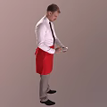 Man in White Shirt Black Tie and Red Apron Holding Device Against Gray Background