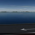 Scenic View With Blue Sky White Clouds Green Hills Blue Water Road And White Arrow