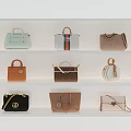 Various Stylish Handbags In Different Styles And Colors Displayed On White Shelves