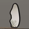 Unique Curved Black Frame Mirror on Light Beige Wall with Green Plant Reflection