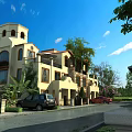 Mediterranean Style Detached Villa With Tower Balconies Arched Windows And Trees Along Driveway With Parked Cars