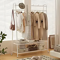 Stylish Hanging Clothes On White Rack With Beige Dresses Coats Bow Details In Bright Room