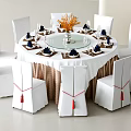 Round Dining Table Set With White Chairs Brown Covers Red Tassels Tableware And Orange Flowers