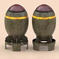 Two Metal Bombs With Red Tops And Yellow Stripes On Stands