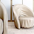 Modern Beige Leather Accent Chair with Curved Upholstered Design in Minimalist Living Room Interior