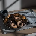 Assorted Donuts On Gray Plate With Gray Cup And Light Blue Cloth On Wooden Table