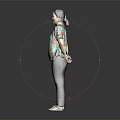 Woman In Colorful Floral Top And Black Pants Standing Against Dark Background