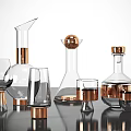 Modern Ceramic Vessels With Gold Accents And Glass Elements On Tabletop