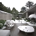 Serene Snowy Courtyard Garden With Wooden Deck Chairs Green Plants And Stone Wall