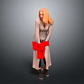 Woman with blonde hair in gray long dress holding red clothing against gray background