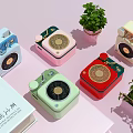 Vintage Style Small Speakers in Multiple Colors with Retro Design and Green Plants