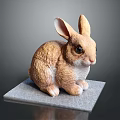 Brown Rabbit Sculpture Sitting On Gray Pad With Detailed Ears And Eyes