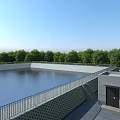 Industrial Factory Water Storage Facility With Metal Railing And Green Trees Background