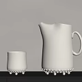 White Ceramic Cup And Pitcher With Pearl Like Bumps On Base On Dark Shelf